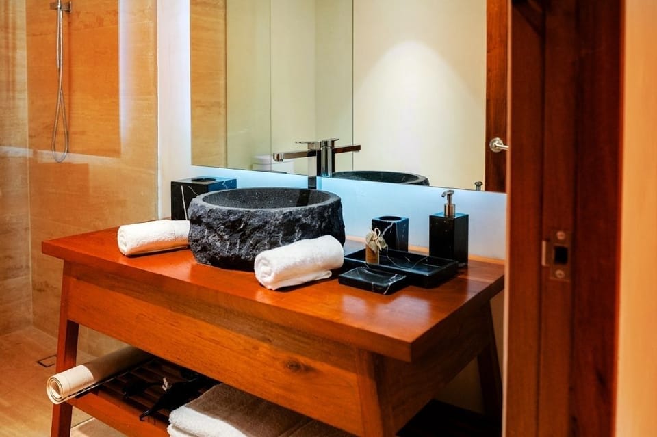 Pamper yourself at the artisan stone basin with fresh towels.
