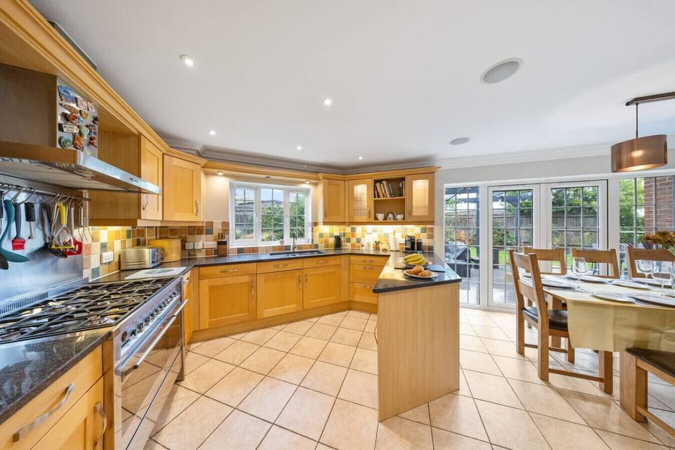This open kitchen and dining space supports group meals with a large table and island.