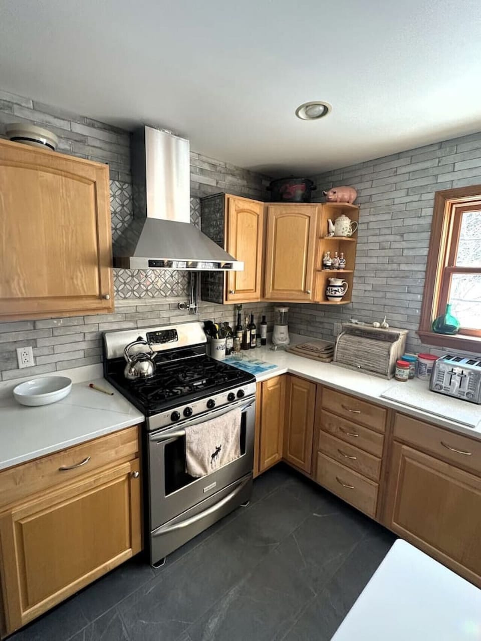 Modern appliances including stove, oven, and dishwasher.