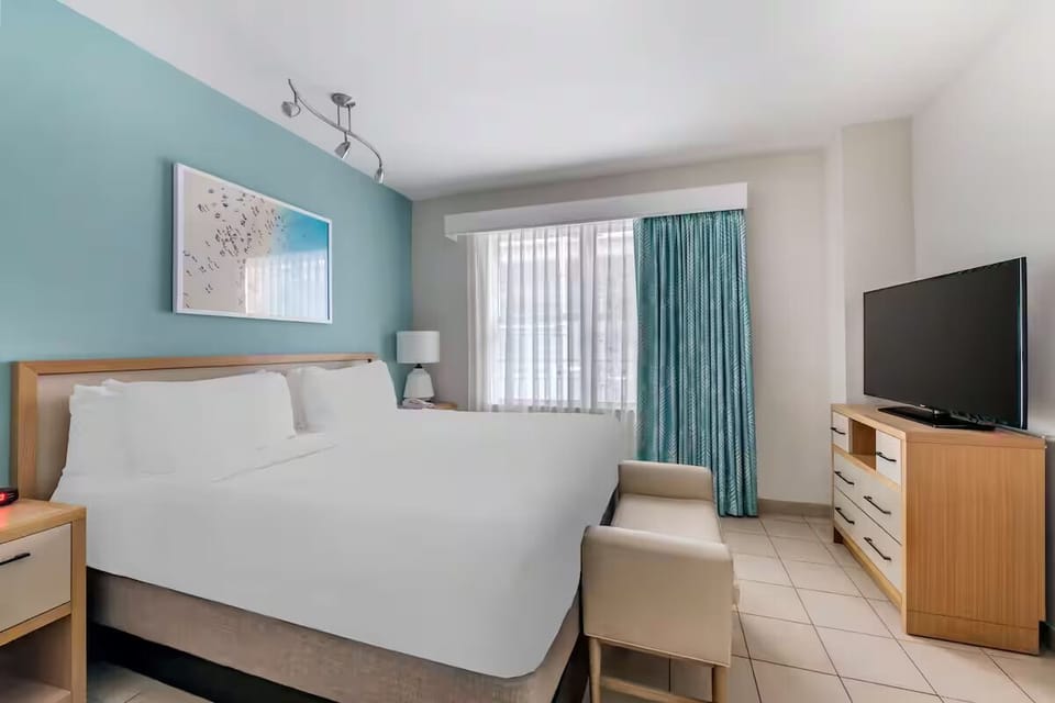 Unwind in crisp linens and wake to soft daylight.