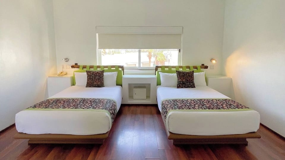 Drift off in twin beds beneath soft, calming daylight.