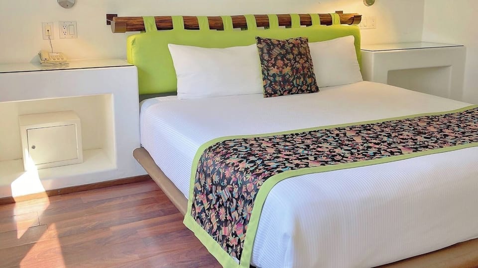 Recharge on a plush king bed with warm wood floors.