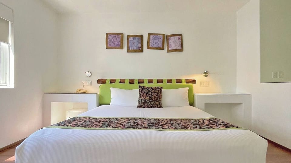 Settle into crisp linens and a calm, airy room.