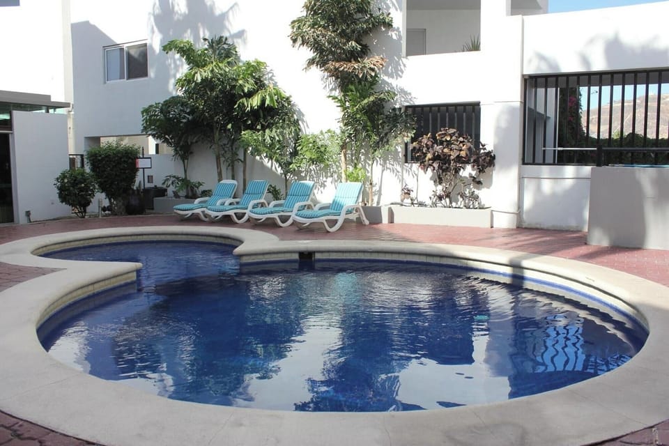 Soak up the day beside the sparkling pool and loungers.