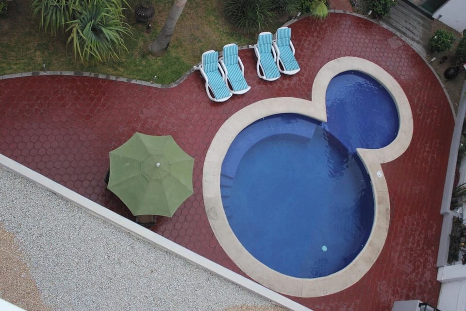 Picture a refreshing dip in this uniquely shaped courtyard pool.