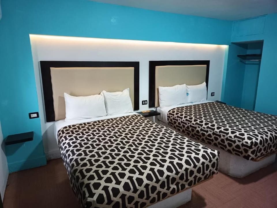 Sink into fresh linens in a modern double-bed retreat.