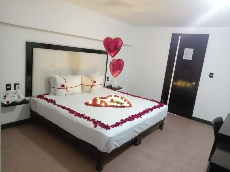 Celebrate a romantic night with petals, candles, and soft light.