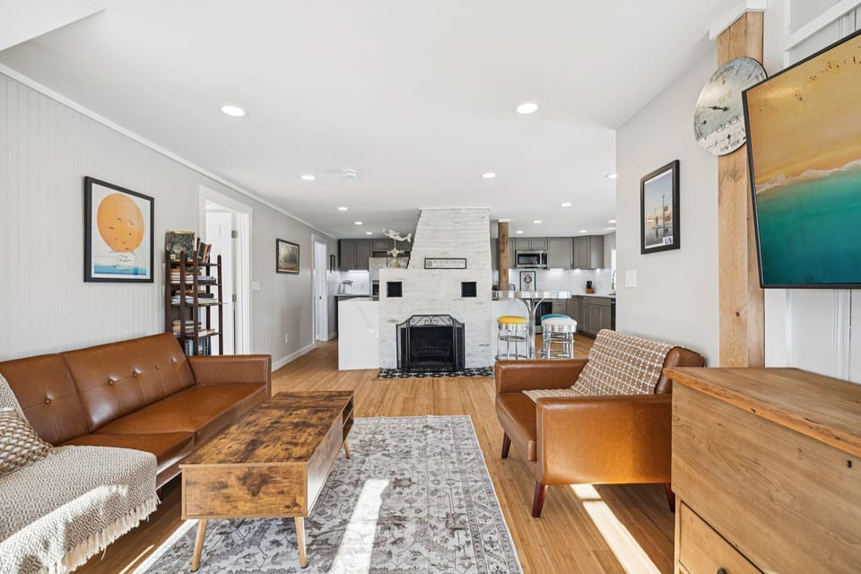 The living room with plenty of seating and a Smart TV. Plenty of natural light also! Please note the fireplace is inoperable and is not to be used.