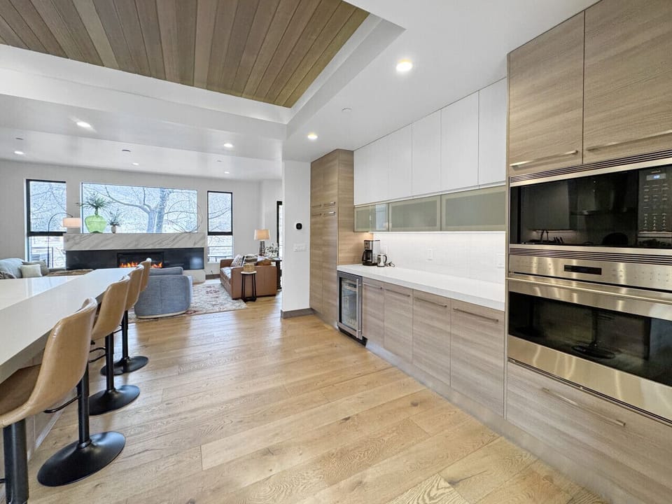 Two ovens running, wine chilled to perfect, bar counter open for business. This side of the kitchen handles the feast while everyone else handles the fun