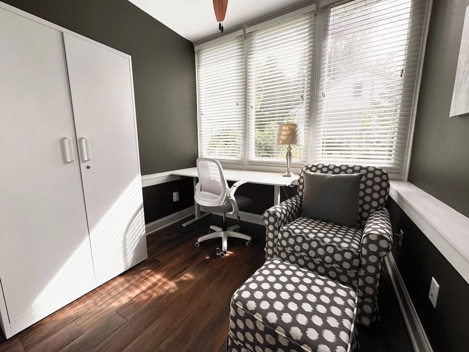 The sunny Garden Level Office includes an electric standing desk and rocking chair.
