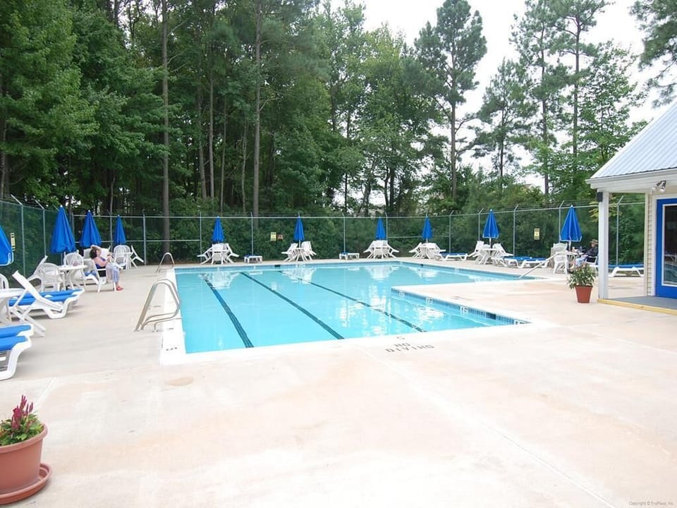 Enjoy access to the nearby community pool with lounge chairs, umbrellas, and space to relax and cool off in the sun.