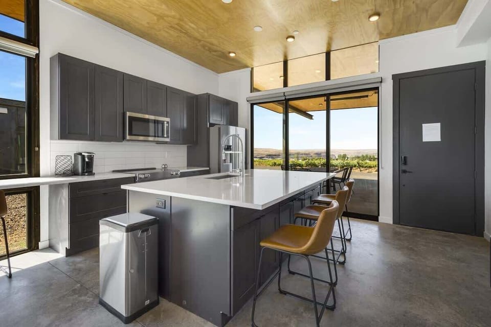 Kitchen.  Keurig, breakfast bar, high end appliances, clean & uncluttered.
