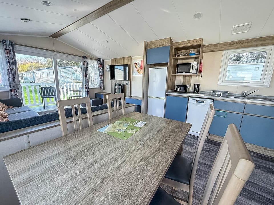 Get the family around the dining table at this modern caravan and enjoy an evening meal followed by games night.