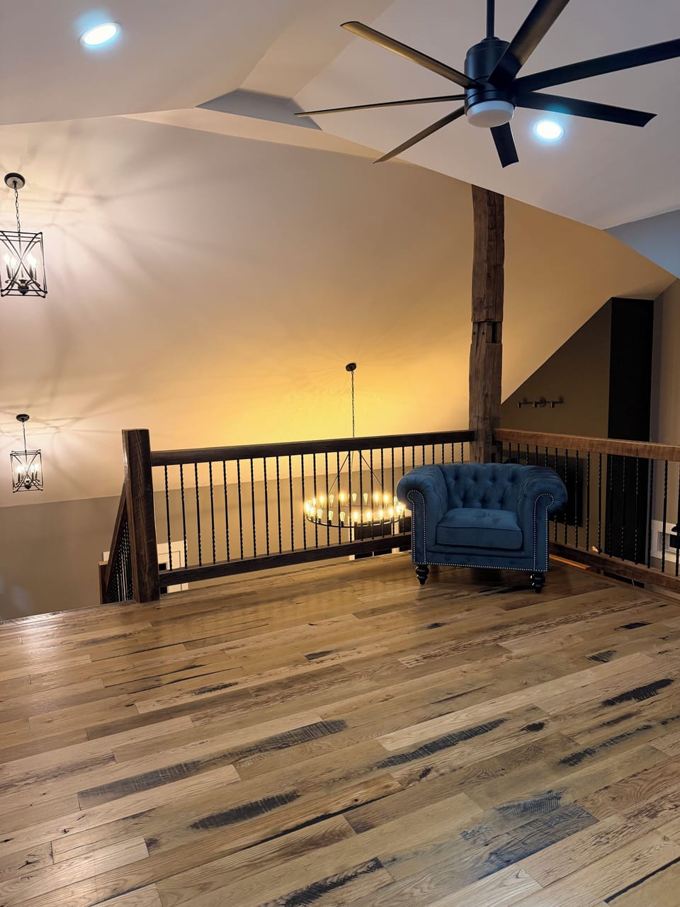 Upstairs loft with plush blue tuffed chair- extra relaxing hangout spot