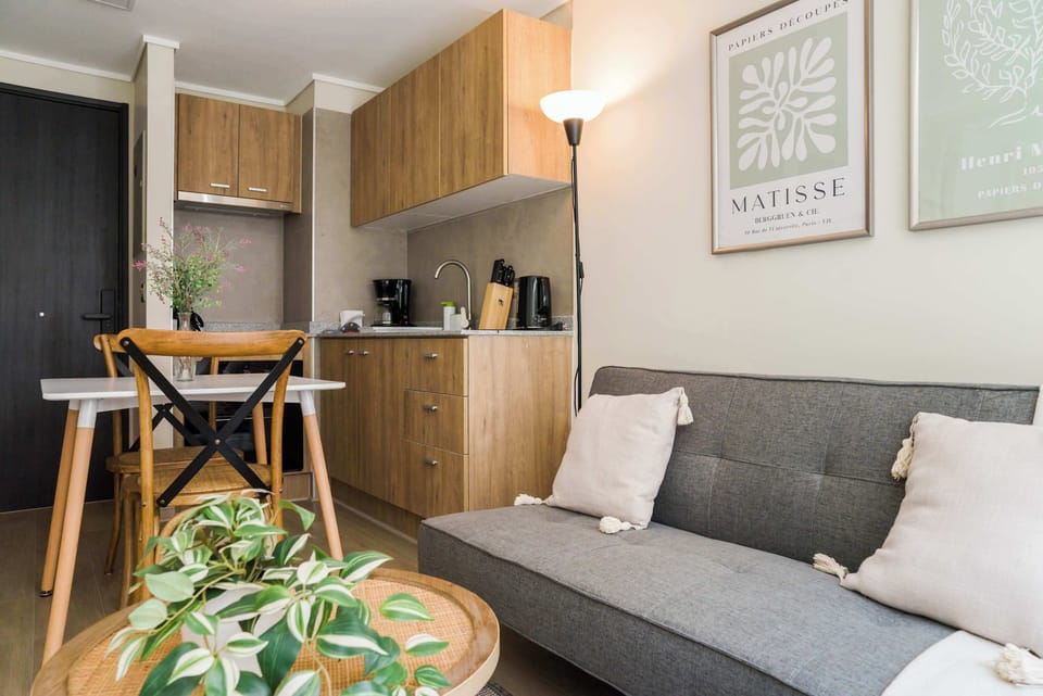 Cozy studio with a stylish living area and compact kitchen, perfect for a comfortable stay in the heart of the city.
