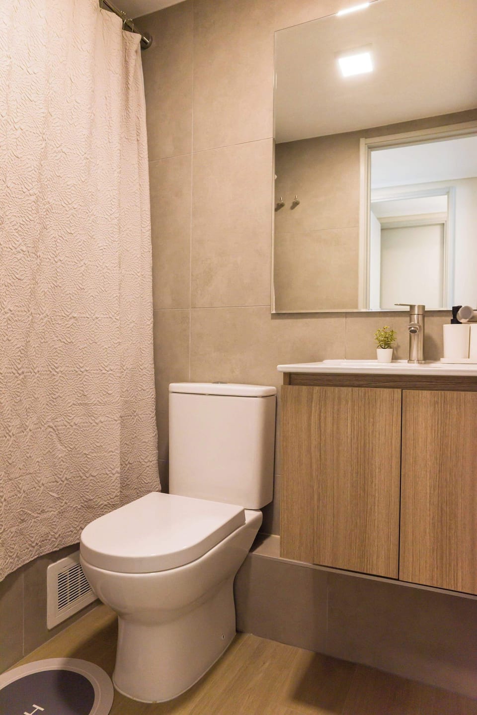 Modern bathroom with sleek fixtures and a cozy ambiance, perfect for unwinding after a day of exploring.