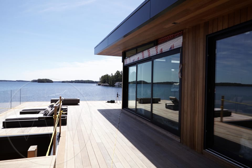 Sunlit waterfront deck with panoramic water views