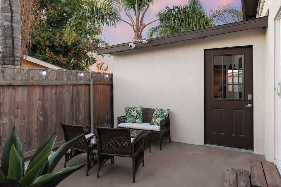 Small private courtyard with seating and potted plants for quiet morning coffee 