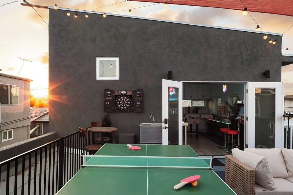 Recreation space with ping-pong table and outdoor-facing windows offering an indoor-outdoor leisure vibe 