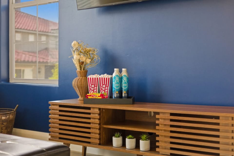 Living Room: Dive into comfort with snacks, stylish decor, and vibrant blue walls!