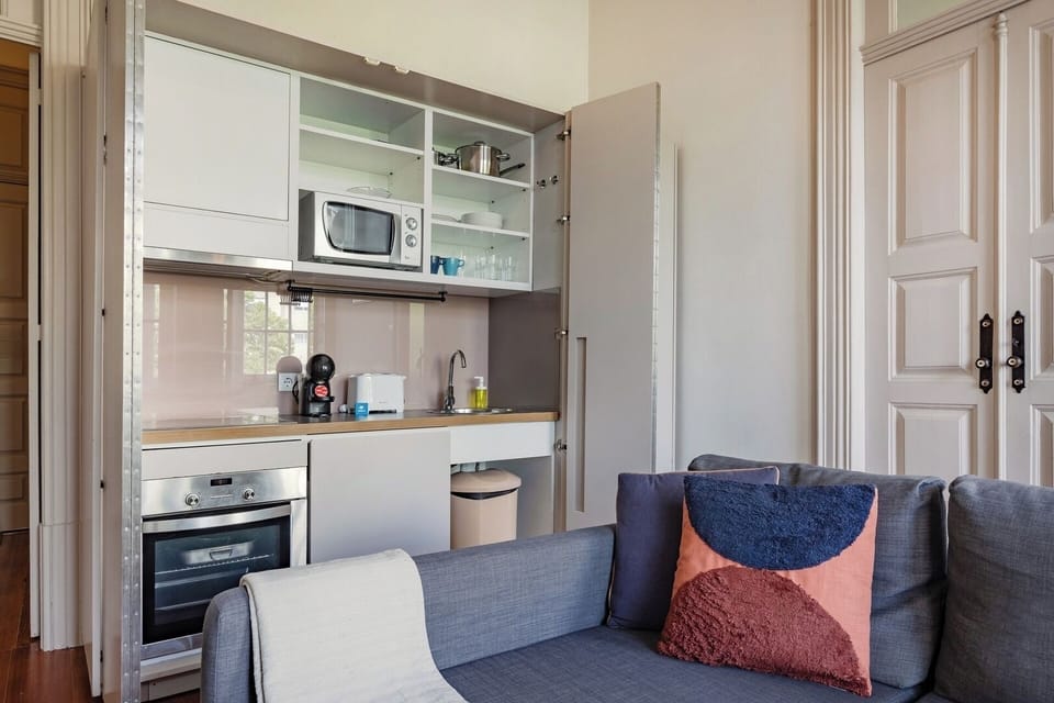 Behind discreet doors, you’ll find a fully equipped kitchenette with dishwasher.