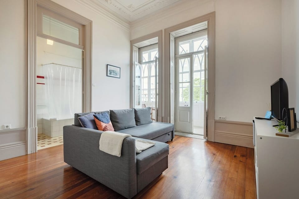 The living room features a cozy chaise-longue sofa-bed and a TV. Behind discreet doors, you’ll find a fully equipped kitchenette. 