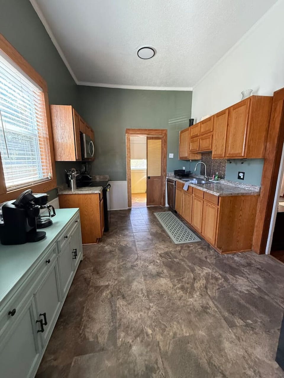 The kitchen is fully stocked with appliances, utensils, cookware, and a dining area suitable for families or longer stays.