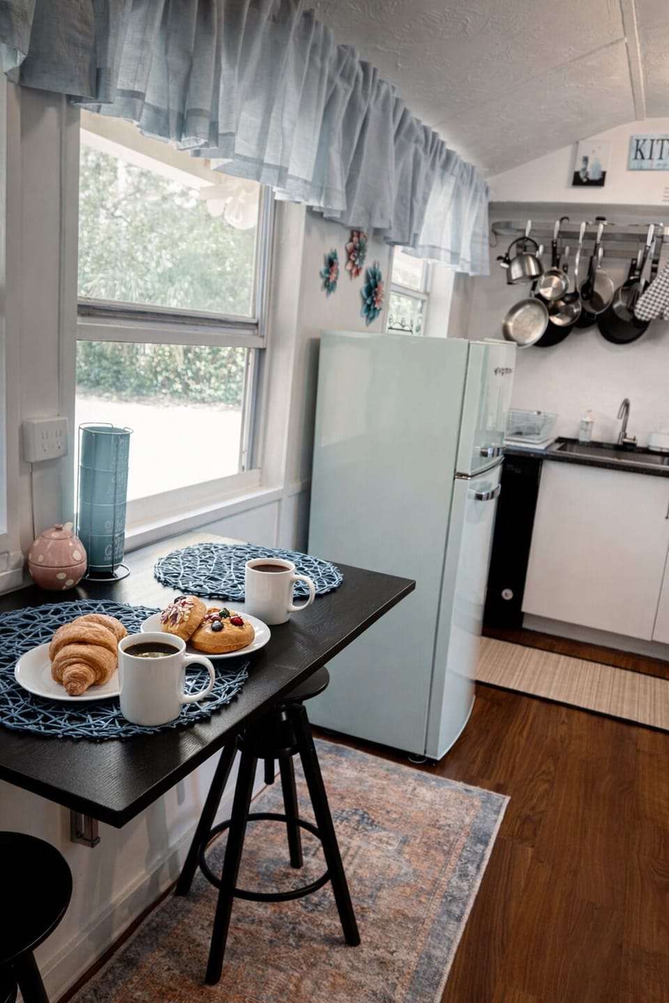 Charming breakfast area with coffee, natural light, and cozy seating