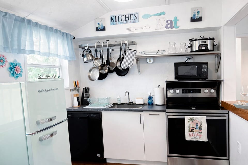 Fully equipped kitchen with modern appliances. and coffee station, 