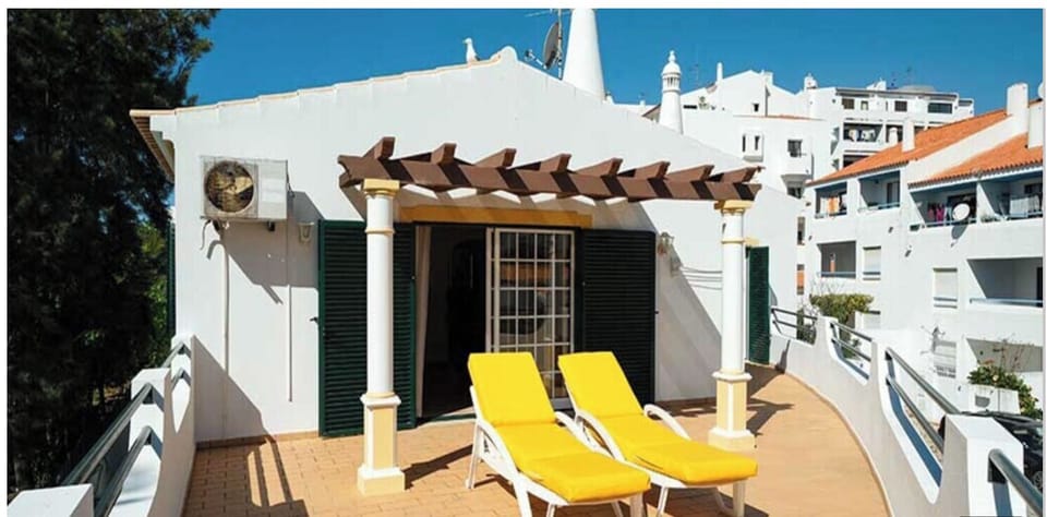 Unwind on sunny loungers under pergola shade, steps from indoors