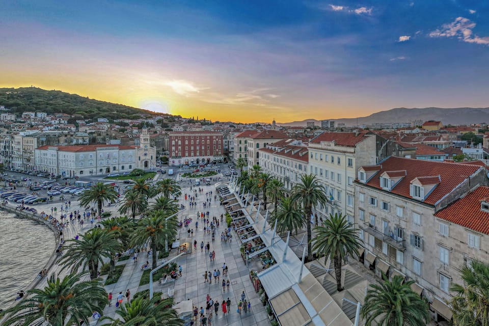 Split’s Riviera - promenade with a view towards Marjan Hill, framed by palm tree