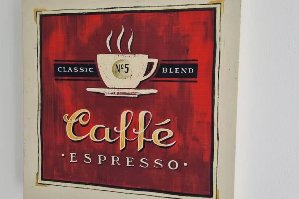 Decorative red canvas print with a café-espresso design displayed on a wall.