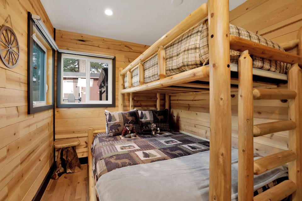 Peaceful cabin bedroom with plush bedding, and beautiful views—ideal for restful nights, cozy mornings, and a relaxing mountain escape.
