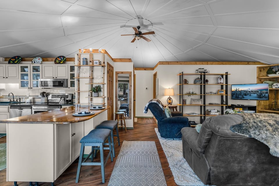 Relax in your spacious open-concept retreat with soaring cathedral ceilings, modern kitchen island, and cozy living area perfect for unwinding.