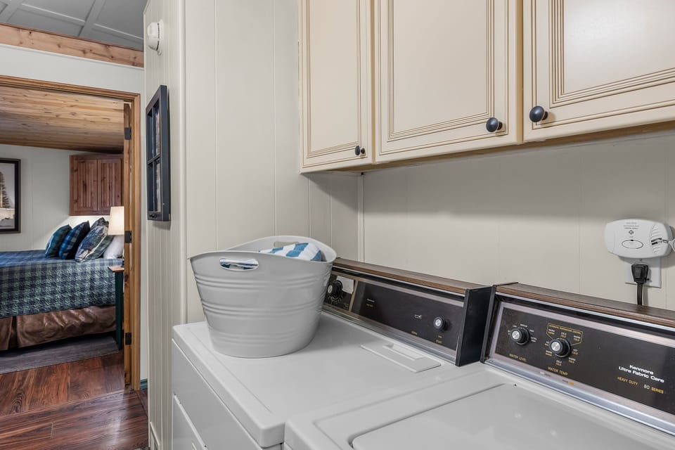 Your private laundry room makes extended stays effortless with a full washer and dryer tucked beneath cream cabinets.