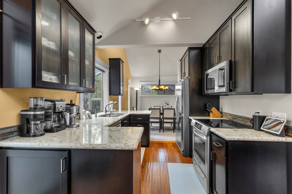 Your gourmet kitchen awaits with granite countertops, stainless appliances, and everything needed to create memorable meals together.