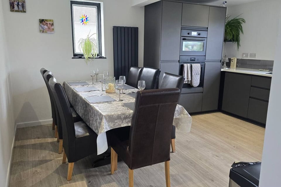 Sit down for meals at the dining table beside the open kitchen area.