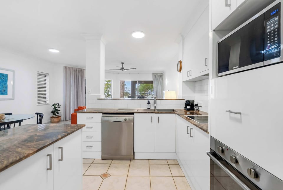 Discover the sleek and functional kitchen, complete with state-of-the-art appliances, a spacious countertop, and convenient storage solutions.