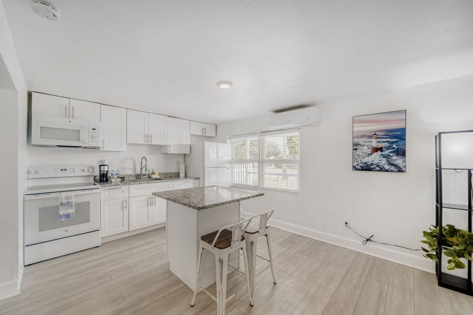 Modern kitchen equipped with full-size appliances, spacious quartz countertops, and all essentials for effortless home-cooked meals.