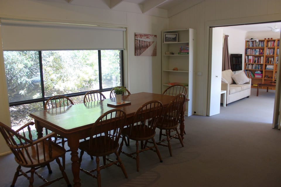 Dining area with entrance to front TV room. 8-seater dining table.