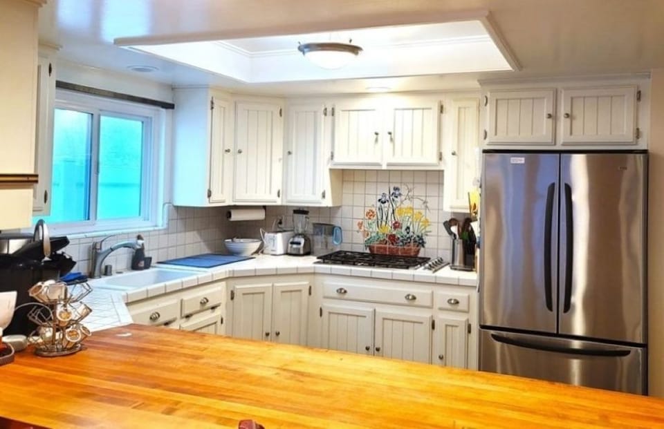 Full kitchen with butcher block counter seating.