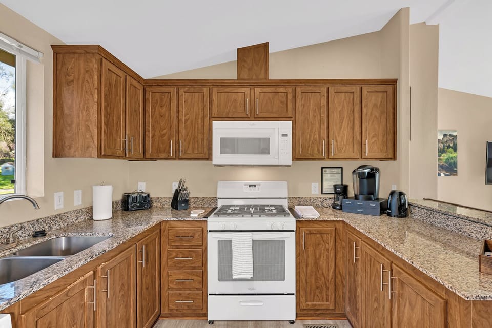 Your fully-equipped kitchen awaits with rich wood cabinetry, and modern appliances.