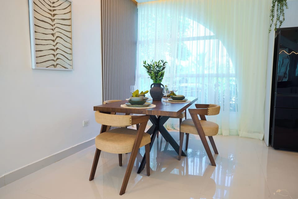 Indoor dining area with seating for four, located next to large windows for natu