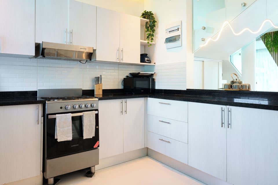 Bright kitchen layout with generous counter space and everything needed for cook