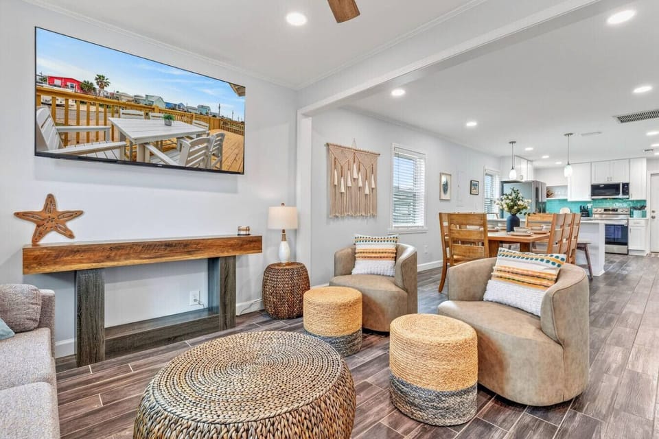 This bright, open living area flows seamlessly into the kitchen with tons of natural light and that perfect coastal vibe.