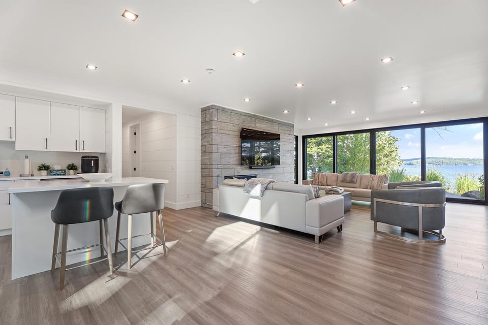 Sunlit open living and kitchen area with scenic views
