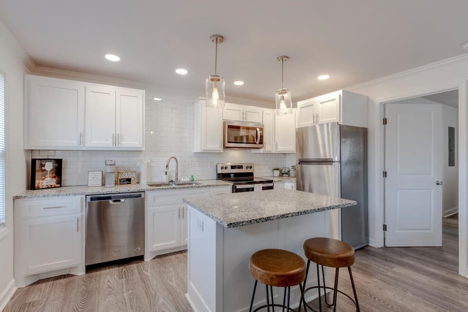 Kitchen island with bar stools and full stainless appliances
