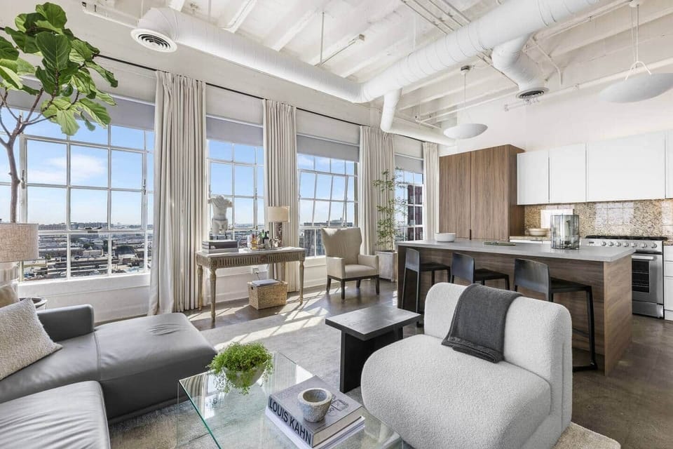 Sleek urban oasis with natural light and a cozy reading nook for enjoying coffee with a view.