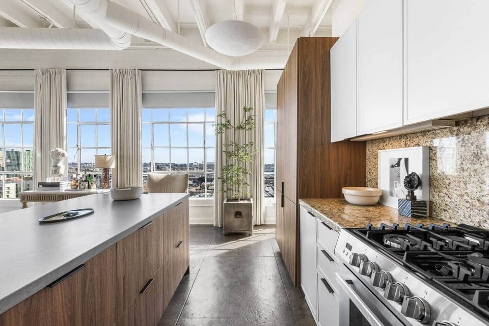 Sun-lit kitchen corner with warm wood accents and an impressive view for a breakfast treat.