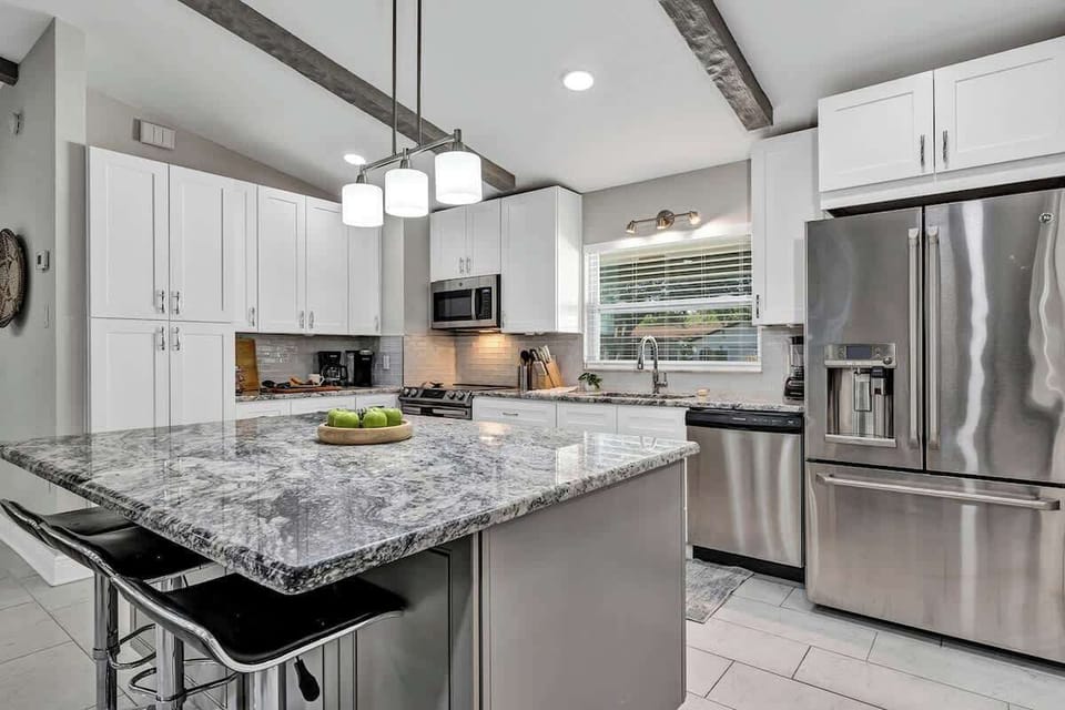 Spacious and elegant full kitchen! Large french door refrigerator, pots, pans, silverware, cooking utensils, blender, air fryer, insta pot, drip coffee machine, Keurig coffee machine, 3 comfortable bar stools around spacious island.
